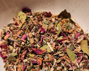 May include: A white bowl filled with a blend of dried herbs and rose petals. The herbs are a mix of green, brown, and beige, with some pink rose petals scattered throughout.
