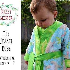 May include: A green and blue robe with a white bunny pattern. The robe has a green sash and is tied at the waist. The text "The Jessie Robe" and "Pattern for sizes 0-7" is printed on the white background.