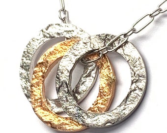 Silver,blackened silver and gold plated sterling silver circle pendant