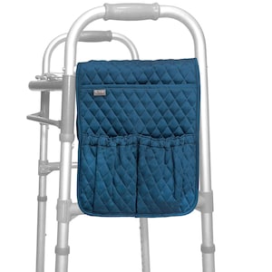 May include: A teal quilted walker bag with two front pockets and a small label. The bag is attached to a silver walker. The bag has a diamond pattern and is designed to hold personal items.