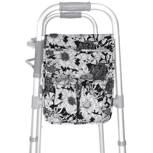 May include: A black and white floral walker bag with multiple pockets. The bag is attached to a silver walker.