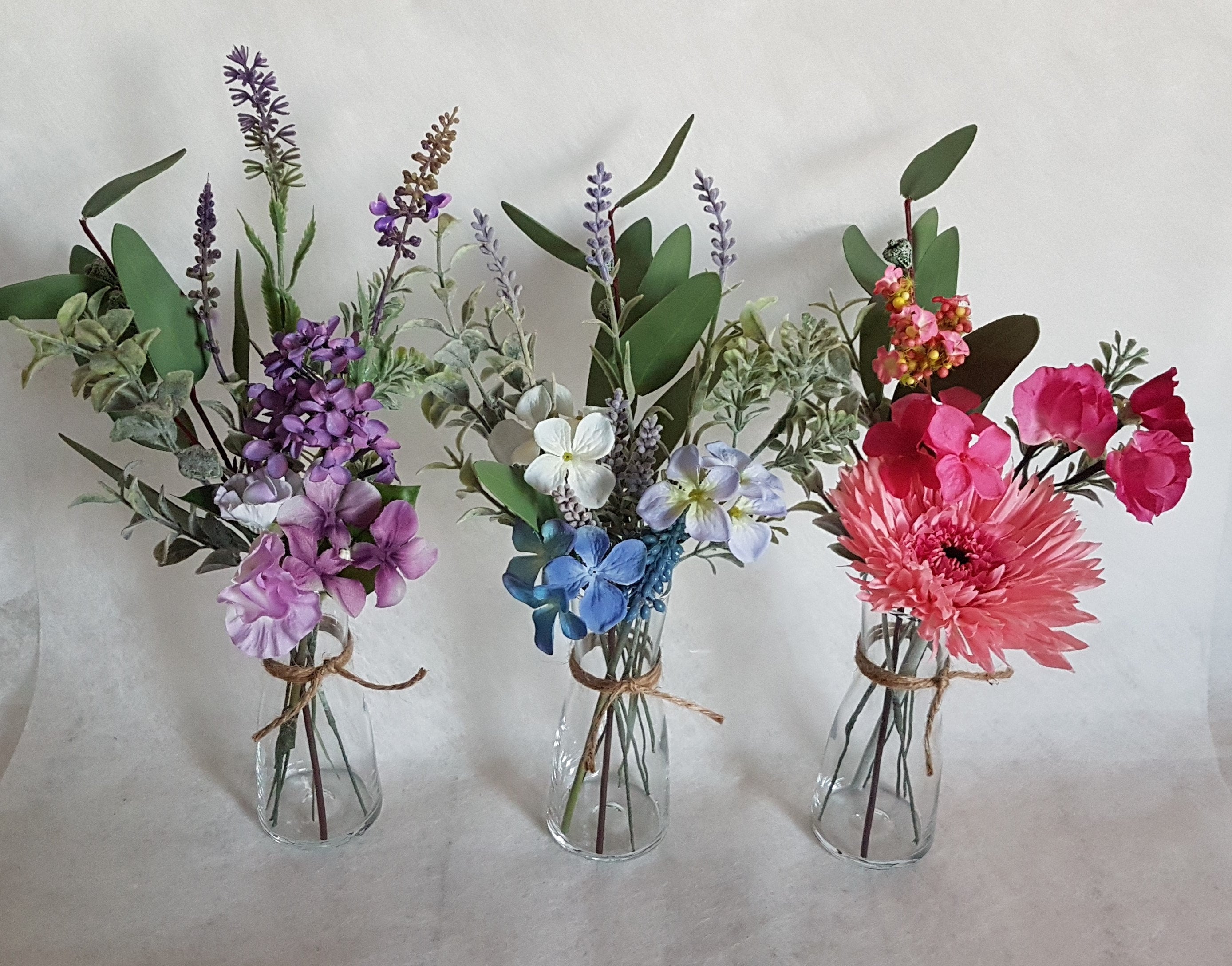 Purple artificial flowers and vase discount