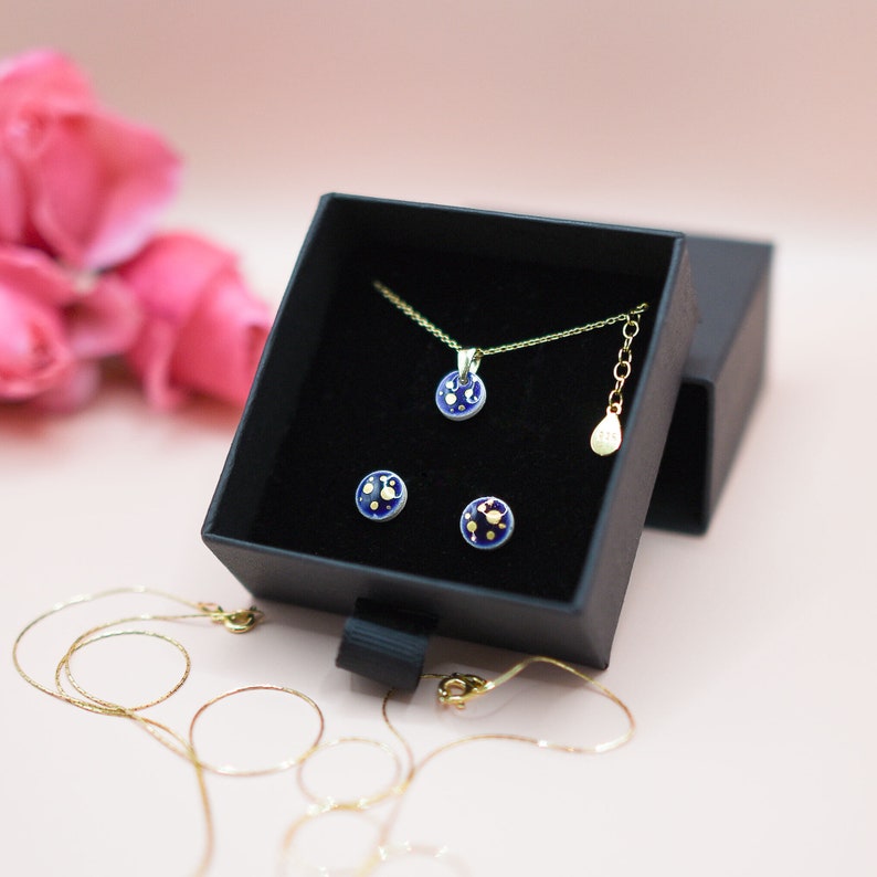 Ceramic navy jewelry set tiny navy stud earrings with gold dots pattern and bracelet with small round navy pendant with gold dots pattern.