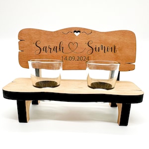 May include: Wooden bench with two shot glasses, personalised with the names "Sarah & Simon" and the date "14.09.2024".