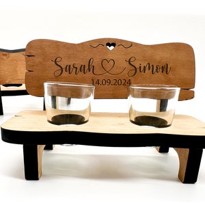 May include: Wooden bench with two shot glasses, personalised with the names "Sarah & Simon" and the date "14.09.2024".