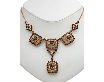 18 karat yellow gold and garnet lady filigree design necklace.