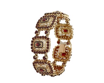 18kt yellow gold and garnet lady filigree design bracelet.