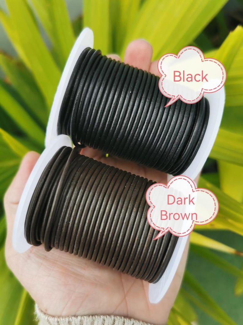 A hand holding two spools of black and brown leather cord, with speech bubbles indicating the color of each spool.