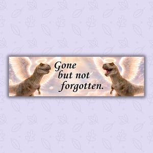 May include: A rectangular banner featuring two cartoon Tyrannosaurus Rex dinosaurs with angel wings and halos. The text "Gone but not forgotten" is written in a script font.
