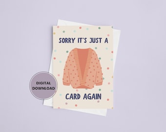 May include: A greeting card with the text "SORRY IT'S JUST A CARD AGAIN" and a cartoon illustration of a peach-colored cardigan sweater. The card has a cream background with colorful polka dots and a digital download label.