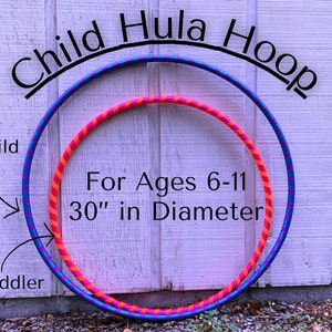 May include: Two hula hoops, one blue and purple with pink and orange stripes, and one pink and orange with blue stripes. The larger hoop is 30 inches in diameter and is labeled "Child Hula Hoop". The smaller hoop is labeled "Toddler". The text "For Ages 6-11" is written below the hoops.