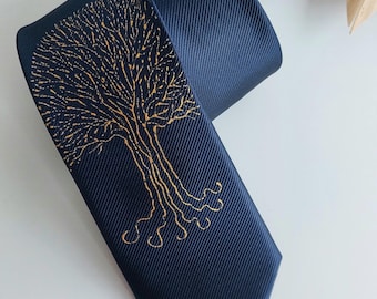 May include: A dark blue silk tie with a gold tree design. The tree has a detailed, intricate design with branches and roots.