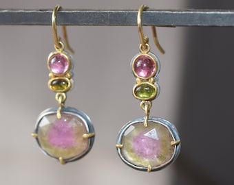 Earrings of watermelon tourmaline set in 22K gold on silver with tourmaline cabochons.