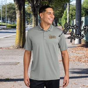May include: A gray polo shirt with a small logo on the left chest. The logo is a brown rectangle with white text. The text reads "SOUTH GEORGIA TECHNICAL COLLEGE,  FOR MY FUTURE,  YOUR BRIGHT START".