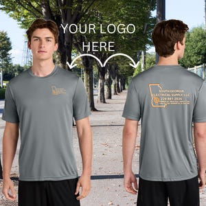 May include: A gray performance t-shirt with a logo on the front and back. The front logo is a stylized outline of the state of Georgia. The back logo says "South Georgia Electrical Supply, LLC" and includes a phone number and the text "Commercial, Industrial,  Residential Lighting".