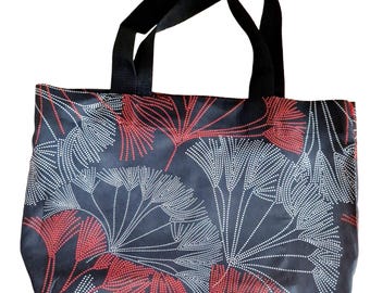 May include: Black tote bag with a floral pattern in red and white. The bag has black handles and a rectangular shape. The floral design features a repeating pattern of dotted lines and leaf-like shapes.