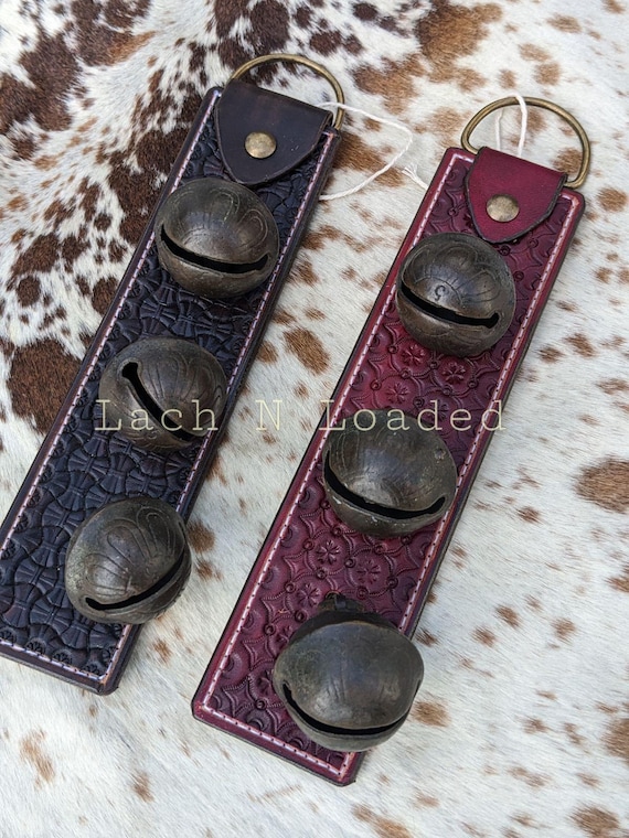 Antique petal style brass sleigh bells door hanger on tooled leather