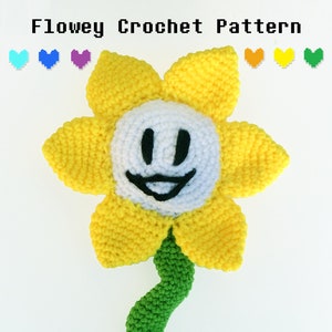 May include: A crocheted Flowey the Flower from the video game Undertale. The flower is yellow with a white face and a green stem.