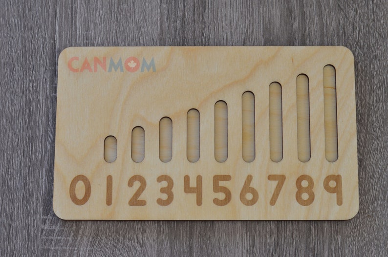 May include: Wooden number learning toy with ten slots and corresponding numbers 0-9. The slots increase in size to represent the increasing value of each number.