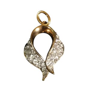 May include: A gold pendant with a heart-shaped design, accented with sparkling clear stones.