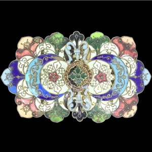 May include: A vintage enamel brooch with a colorful floral design. The brooch features a central motif of a green flower surrounded by white flowers with gold accents. The design is framed by a border of blue, green, and pink enamel.