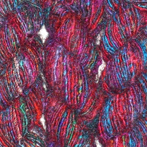 May include: Close-up of a skein of yarn with a mix of red, blue, and purple fibers. The yarn is soft and fluffy, and it has a slightly iridescent sheen.