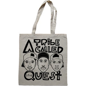 May include: A white tote bag with black text and illustrations. The text reads "A Tribe Called Quest" with three black and white illustrations of men's faces.