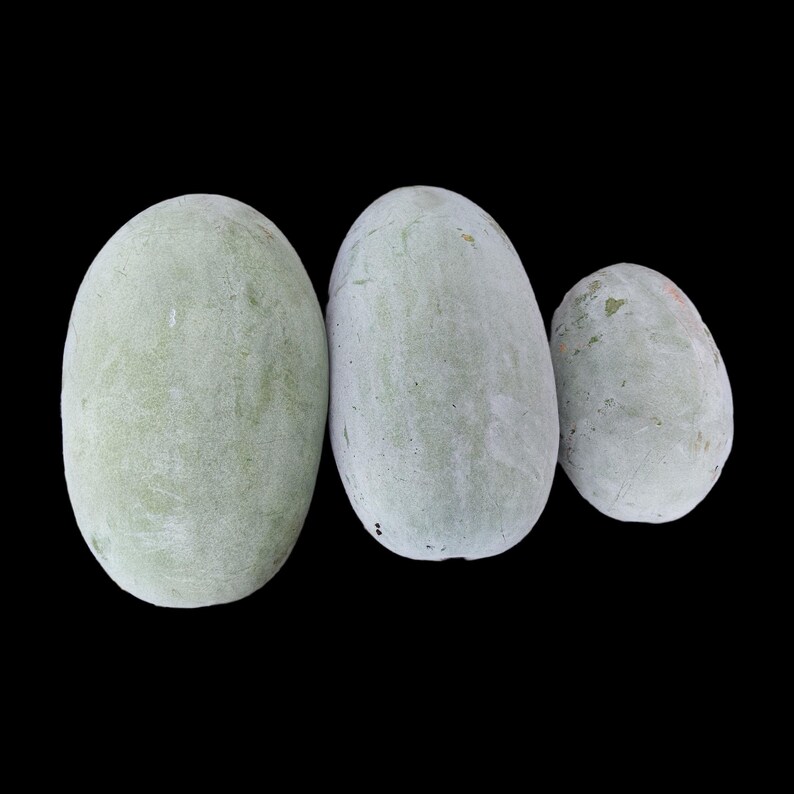 a group of three rocks sitting next to each other