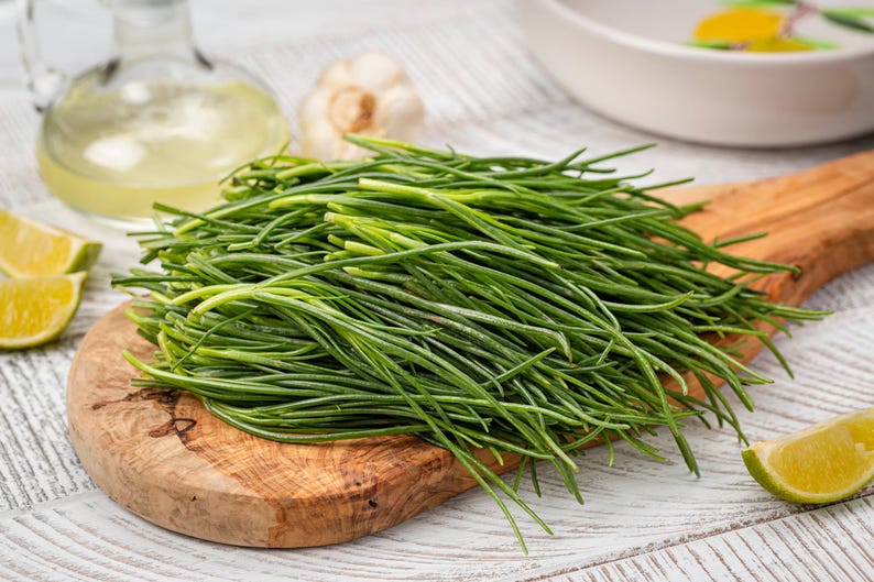 a bunch of green grass sitting on top of a wooden cutting board
