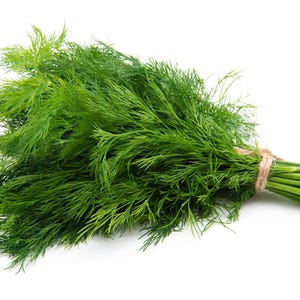 a bunch of green grass sitting on top of a white surface