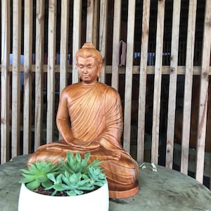 The Wooden Sitting Buddha statue