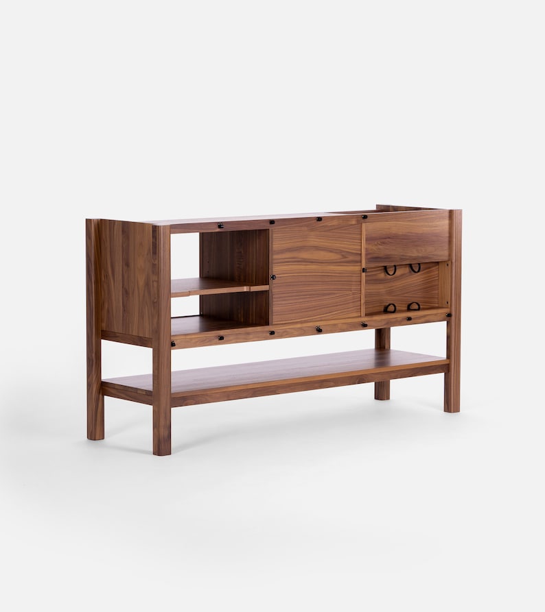 May include: A wooden cabinet with a sliding door, two drawers, and a lower shelf. The cabinet is made of walnut wood and has a natural finish.