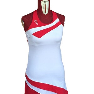 May include: White sleeveless dress with red diagonal stripes and a red and white asymmetrical hem.
