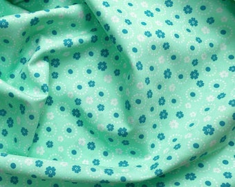 Floral fabric mint printed with small dots, circles and flowers in white and petrol, 100% cotton available from 0.5 m