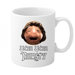 May include: White ceramic mug with a black and white image of a character from the movie Labyrinth. The text "Ucan Ucan Thirsty" is printed below the image.