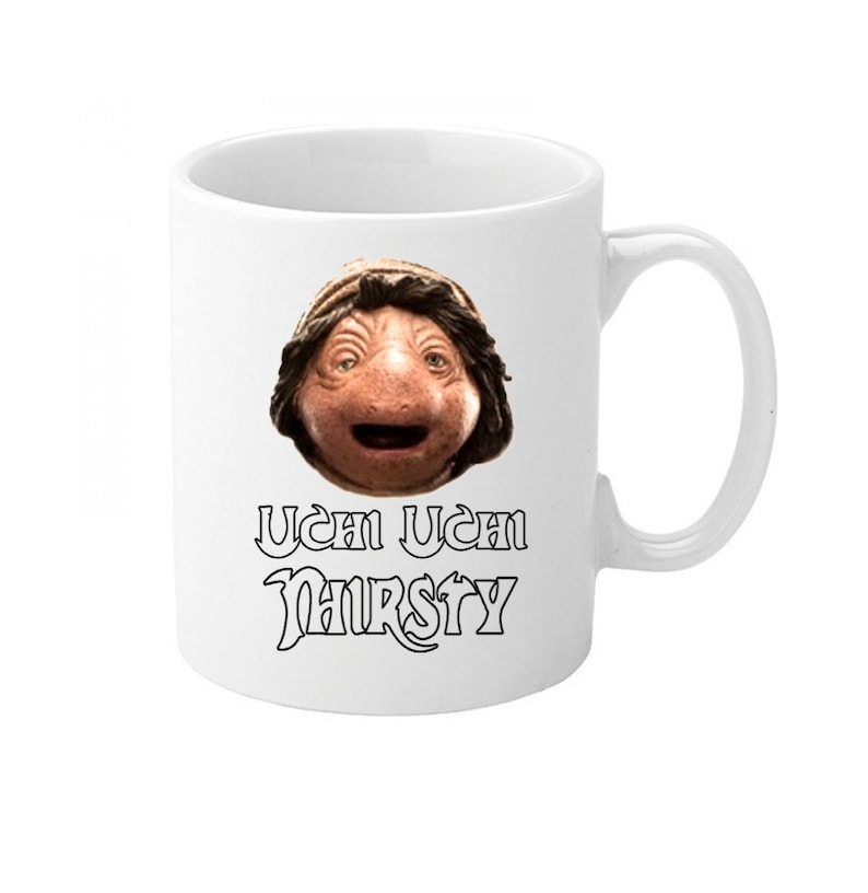 May include: White ceramic mug with a black and white image of a character from the movie Labyrinth. The text "Ucan Ucan Thirsty" is printed below the image.