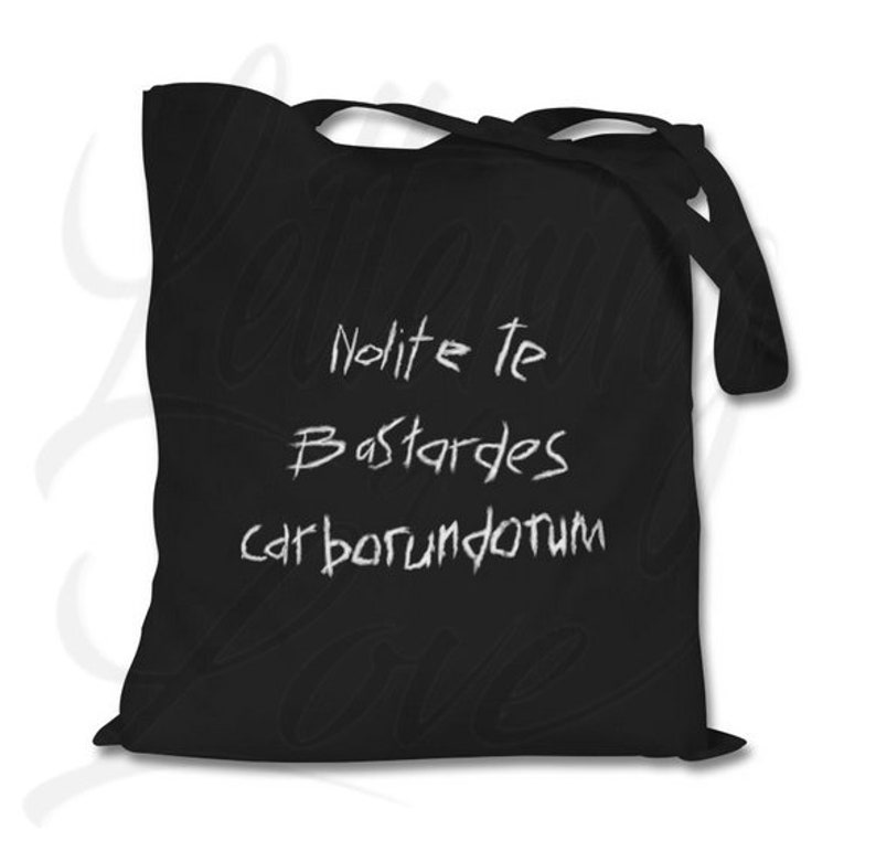 Pu&ograve; includere: Borsa tote nera con testo bianco che recita "Nolite te Bastardes carborundum".