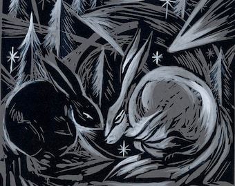 May include: A black and white linocut print featuring two rabbits in a forest setting. One rabbit is black, the other is white. The background includes stylized trees and stars, creating a wintery scene.