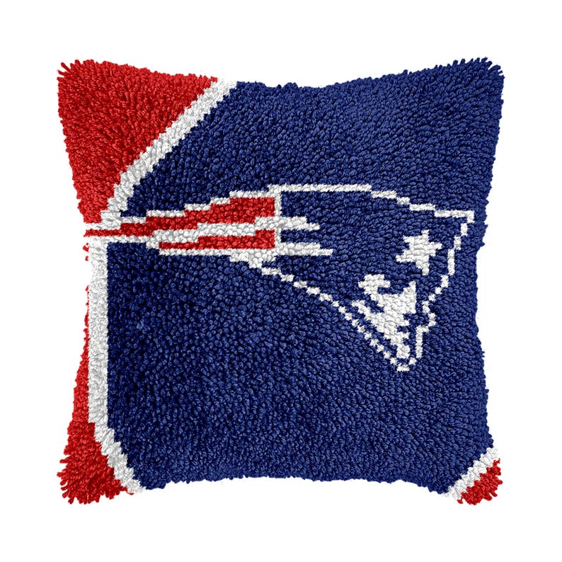 May include: Blue and red throw pillow with a white embroidered football team logo. The logo is a stylized football helmet with a star on the side.