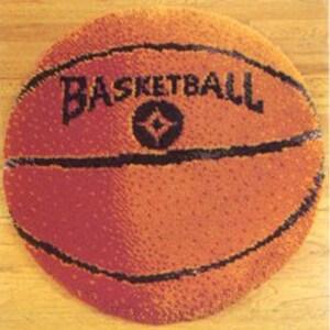 May include: Round orange basketball rug with black lines and the word "BASKETBALL" in black letters. The rug is designed to resemble a basketball, with a textured surface.