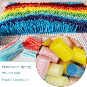 May include: Close-up of colorful yarn spools for rug hooking. The yarn is wrapped around small, cylindrical spools. The yarn is in various colors, including pink, yellow, blue, and white. The yarn is arranged in a pile. The text "Professional dyeing Will not fade Machine washable" is visible in the image.