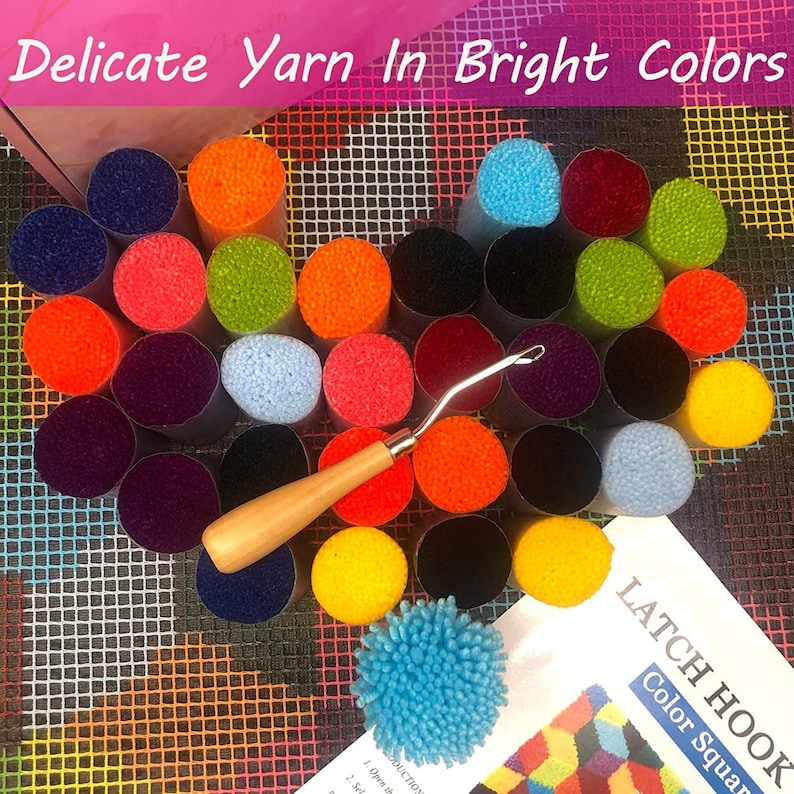 May include: A set of colorful yarn in various shades, including red, orange, yellow, green, blue, purple, and black. The yarn is arranged in a circle around a wooden latch hook tool. The yarn is labeled "Latch Hook Color Square".