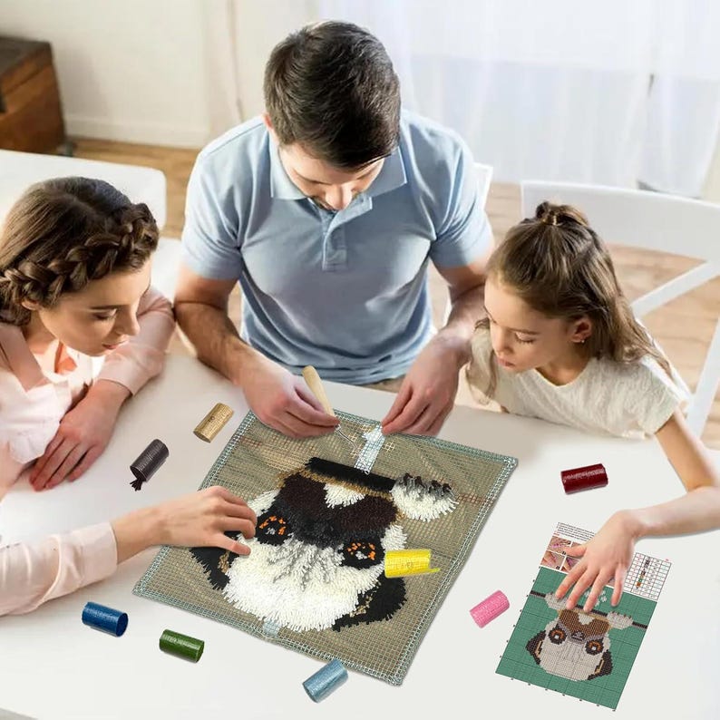 May include: A family is working on a colourful rug hooking project. The project features a pug dog with brown, black, and white fur. The rug hooking kit includes a canvas, yarn, and a tool for hooking the yarn into the canvas.