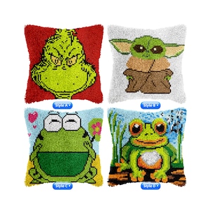 May include: Four different styles of plush pillow kits. The first pillow features a green Grinch character on a red background. The second pillow features a green Baby Yoda character on a white background. The third pillow features a green frog on a blue background with pink hearts. The fourth pillow features a green frog on a blue background with a white flower.