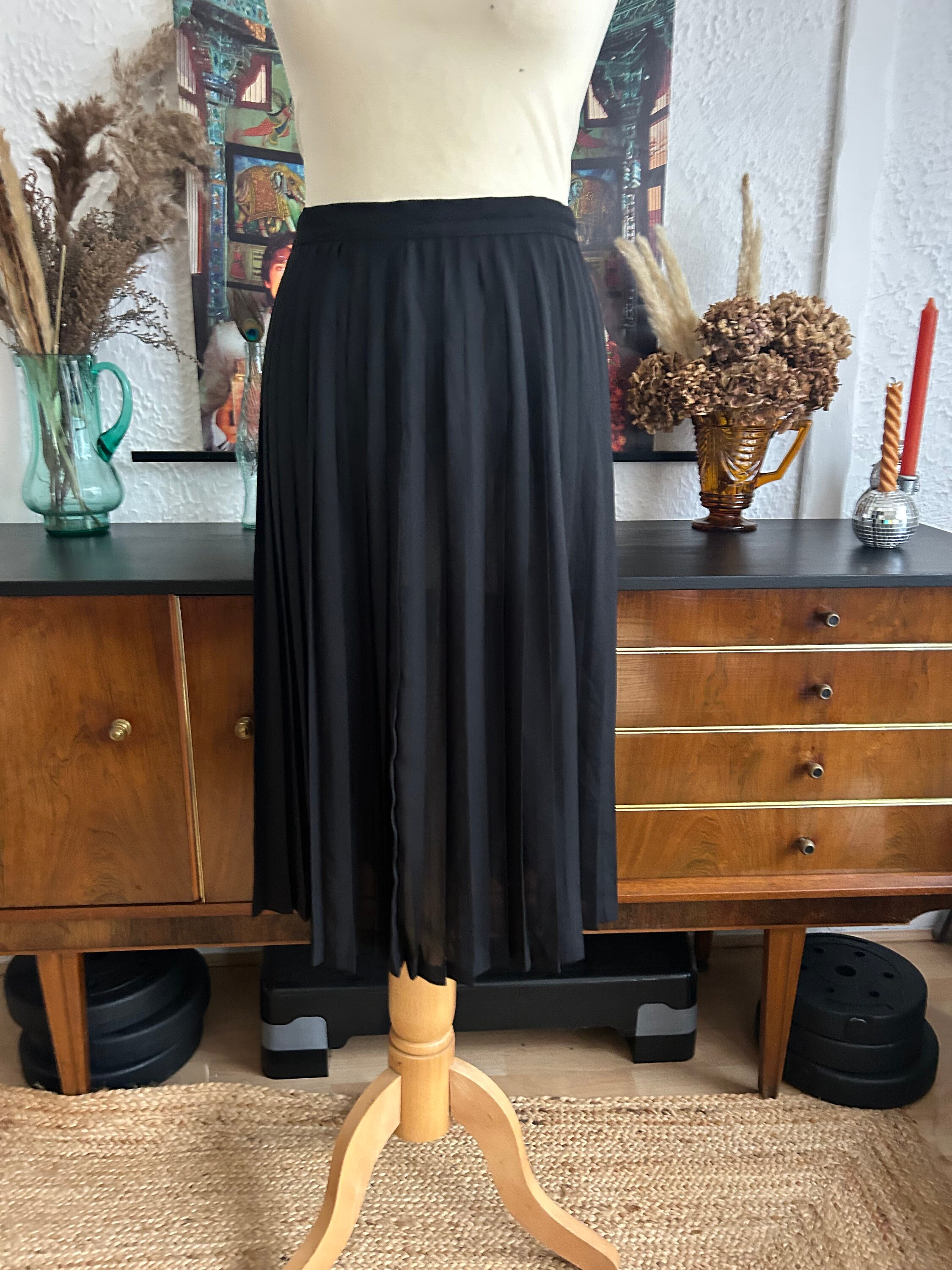 Mid length black pleated skirt top