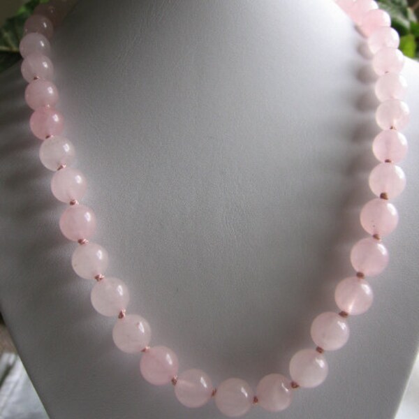 10mm Rose quartz necklace. Silk knotted. Gold tone hook clasp. Promotes emotional wellness.