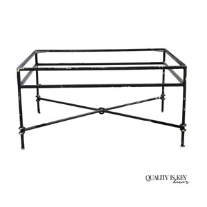 May include: Black metal table base with a rectangular top and a criss-cross design on the bottom. The base is made of wrought iron and has a distressed finish.