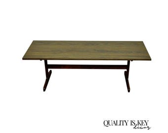 May include: A rectangular wooden table with a dark brown frame and legs. The tabletop is a light brown color. The table is approximately 60 inches long and 30 inches wide.