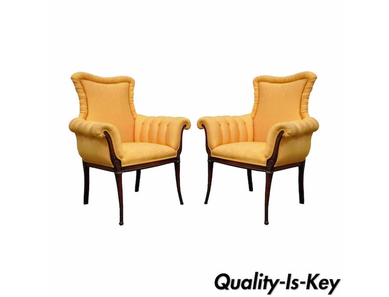 May include: A pair of yellow upholstered armchairs with wooden frames. The chairs have a high back and a curved design.