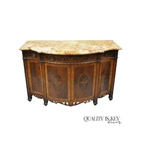 May include: A curved antique sideboard with a marble top and intricate marquetry details. The sideboard has three doors and is made of dark wood.